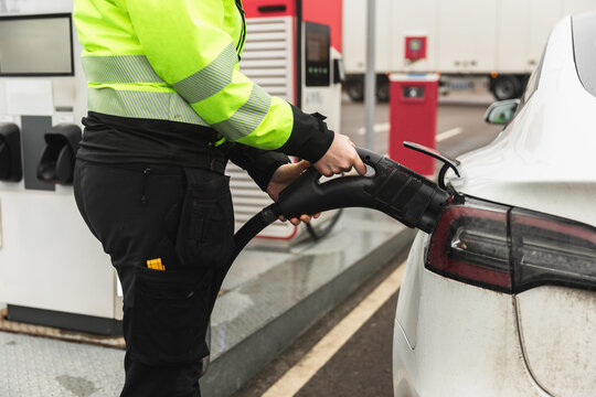 Close-up of Technician Connecting EV Charging Cable