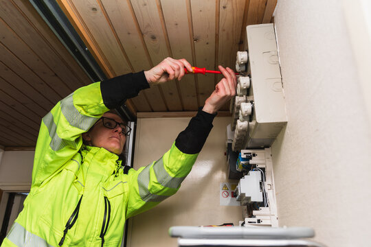 Technician Performing Maintenance on Electrical Fuse Box