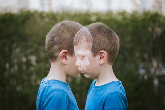 Double exposure shot of a young boy. Dual portrait face to face.