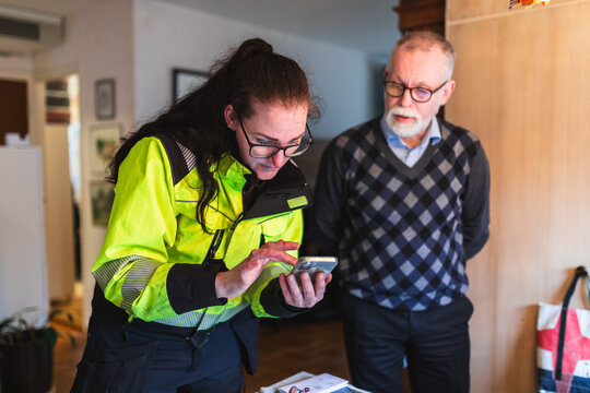Energy Consultant Showing System Diagnostics to Senior Homeowner