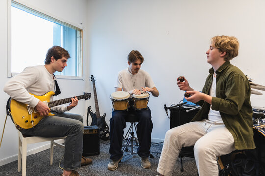 Student music band practicing together in a bright room