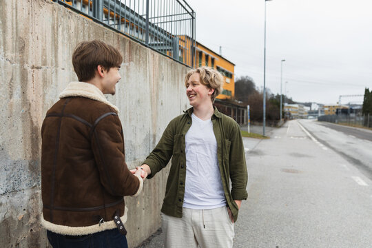 Two Young Men Shaking Hands