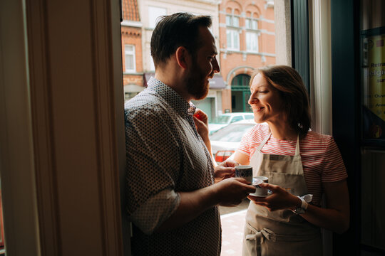 Happy couple sharing espresso in cozy setting