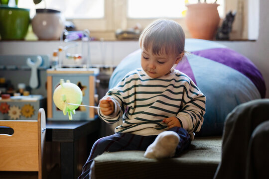 Toddler Playing With Toy At Home