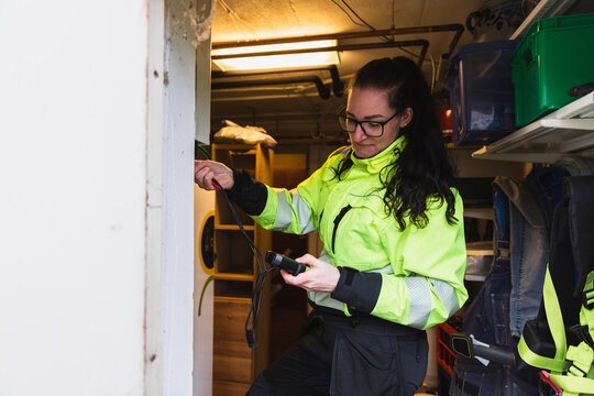 Technician Measuring Electrical Data Indoors
