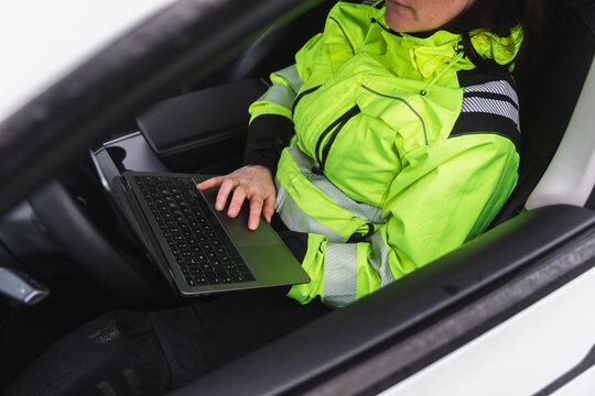 Technician Using Laptop Inside Service Vehicle