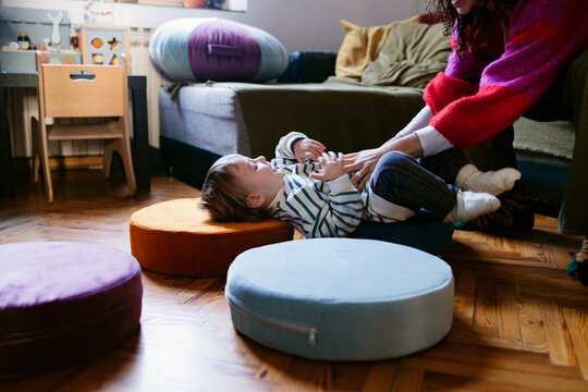 Mother Playing With Child On Living Room Floor