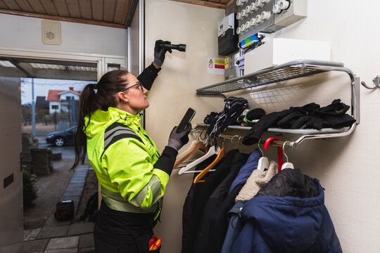 Technician Inspecting Electrical Fuse Box