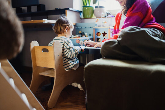 Mother And Toddler Playing Together At Home