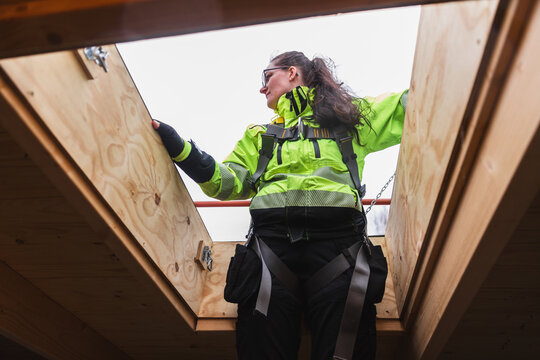 Technician Accessing Roof Through Hatch