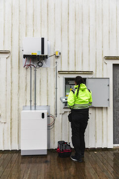 Specialist Checking Control Panel of Home Energy Storage System
