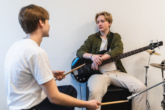 Band Members Discussing Music During Rehearsal Break