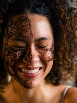 Woman Enjoys Spa Treatment With Coffee Scrub on Her Face