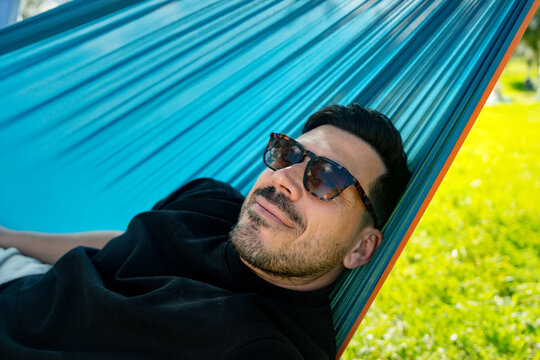 Man Relaxing in Hammock
