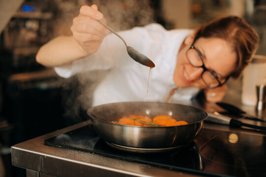 Chef checking sugar syrup from caramelized apricots sauce with s
