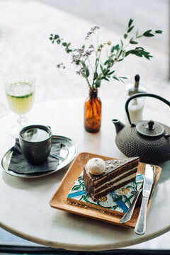 Tea and dessert served on round table in outdoor cafe