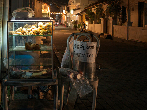 Street Vendor Selling Ginger Tea and Snacks at Night