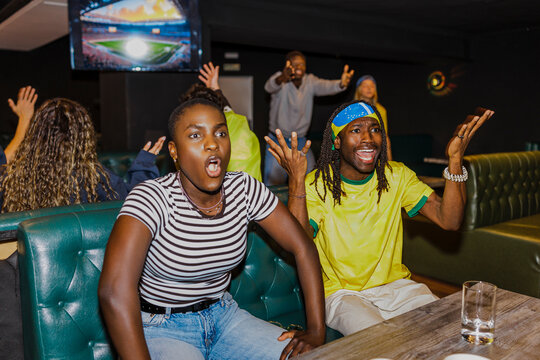 Enthusiastic sports fans reacting emotionally during a game