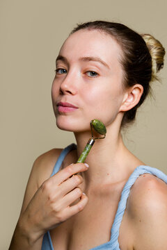 Woman Using Jade Roller