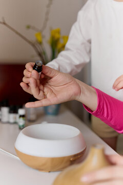 Mother and child using essential oil diffuser at home
