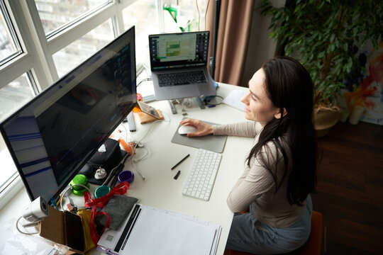 Woman at Workspace with Laptop and Keyboard