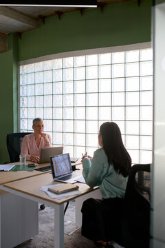 Women talk to each other at the office