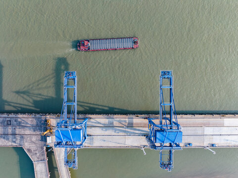 Overhead aerial view of port cranes and barge