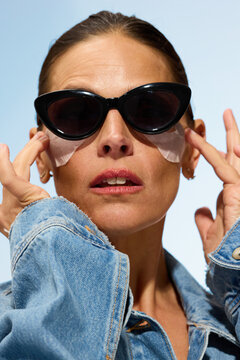 Woman Wears Black Sunglasses and Skin Patches Outdoors During Day