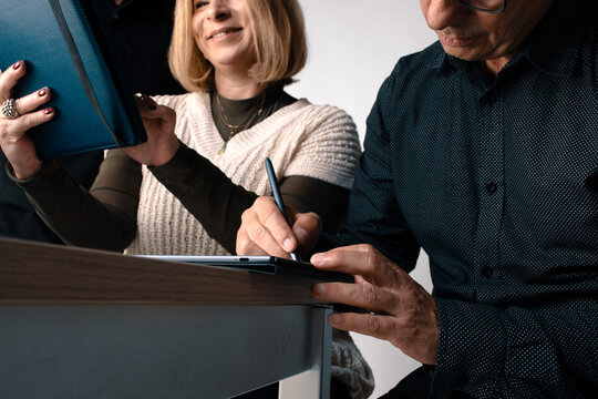 Two People Working Together on a Document at a Table in an Office