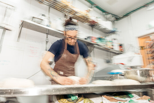 Baker preparing artisan dough for baking bread