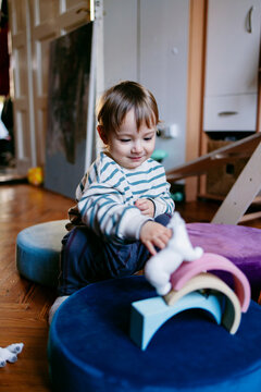 Toddler Playing With Wooden Toys At Home