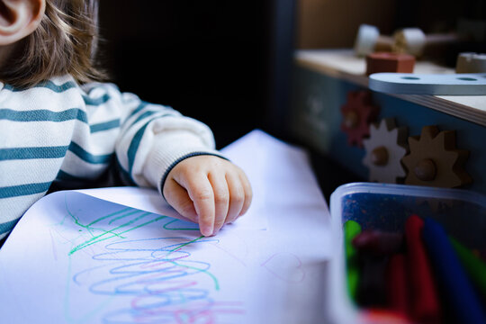 Toddler Drawing With Crayons At Home Table
