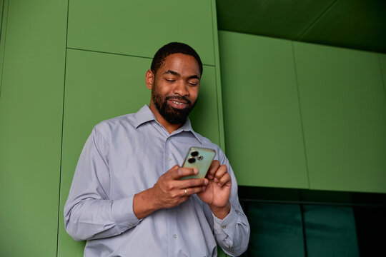 Businessman looks at his phone