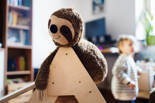 Plush Sloth Toy On Wooden Play Structure At Home