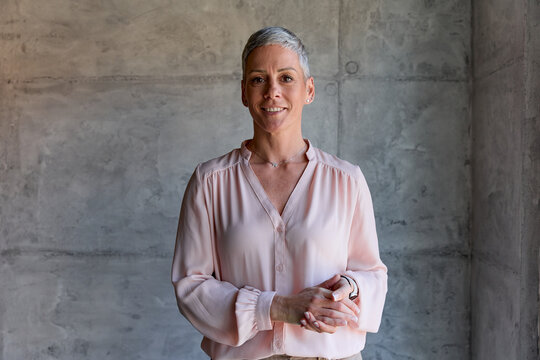 Elegant businesswoman smiles at the camera