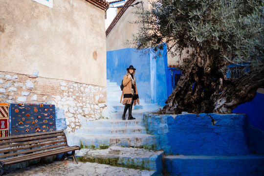 A woman walks in Chefchaouen old town, Morocco