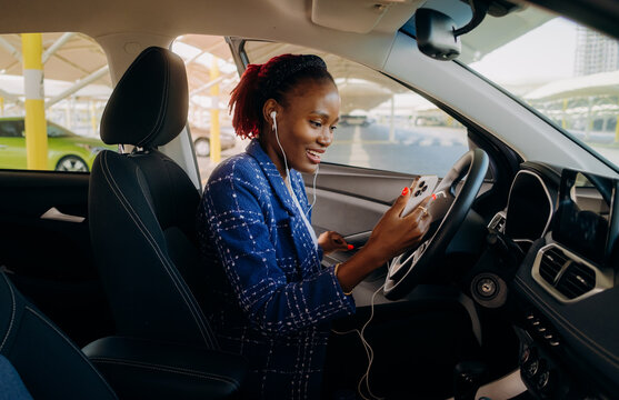 A woman using a mobile phone in a car