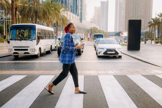 A woman at a pedestrian crossing