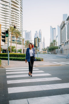 A woman at a pedestrian crossing