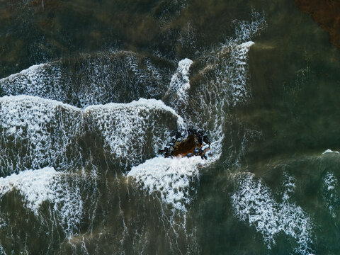 top view of waves breaking over reef in Tulum Mexico