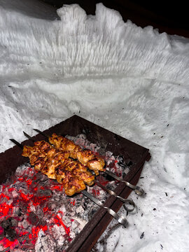 Cooking Meat on Skewers in Winter Snow-Covered Outdoor