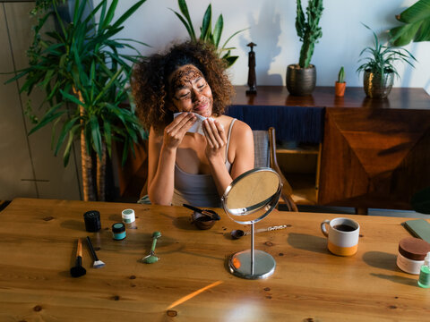 Woman Removes Face Mask at Home During Morning Routine