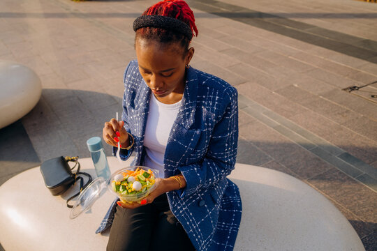 A woman eating lunch outdoors