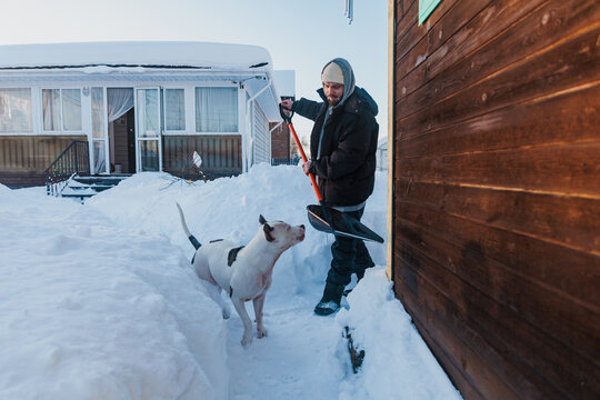 Man Routinely Shovels Snow With Dog In ColdWinter