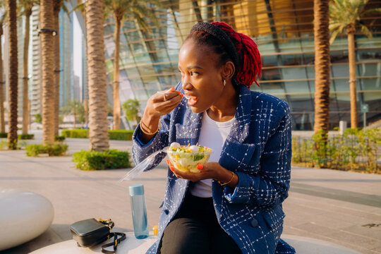 A woman eating lunch outdoors
