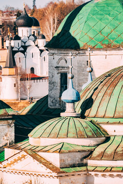 Historic church rooftops with green domes in Russia during daylight