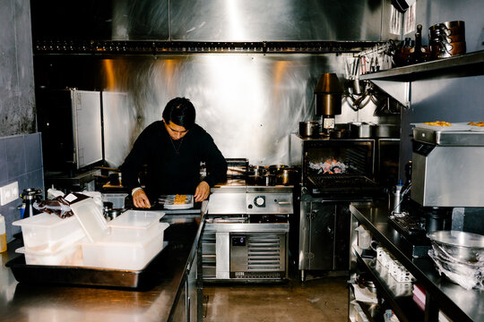 A chef working at a kitchen counter in a specialty restaurant