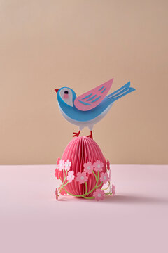Paper spring craft bird on floral easter egg