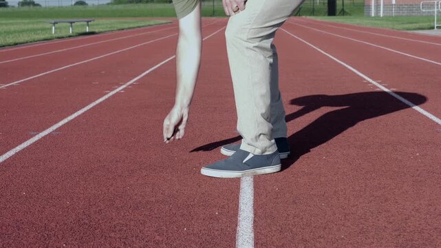 Unsuspecting man finds lost USB thumb drive on ground illustrating malicious USB drop attack - Cybersecurity Information Technology Concept