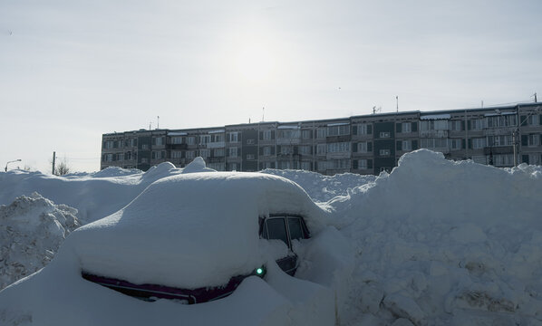 Snow Covers Cars and Buildings in Winter Scene In Small Town
